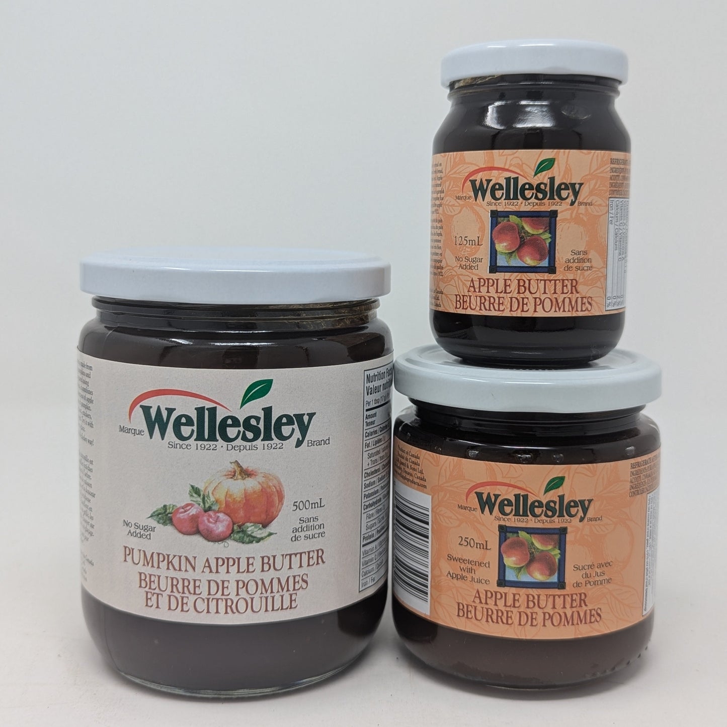 Three jars of Wellesley pumpkin and apple butter on a white background