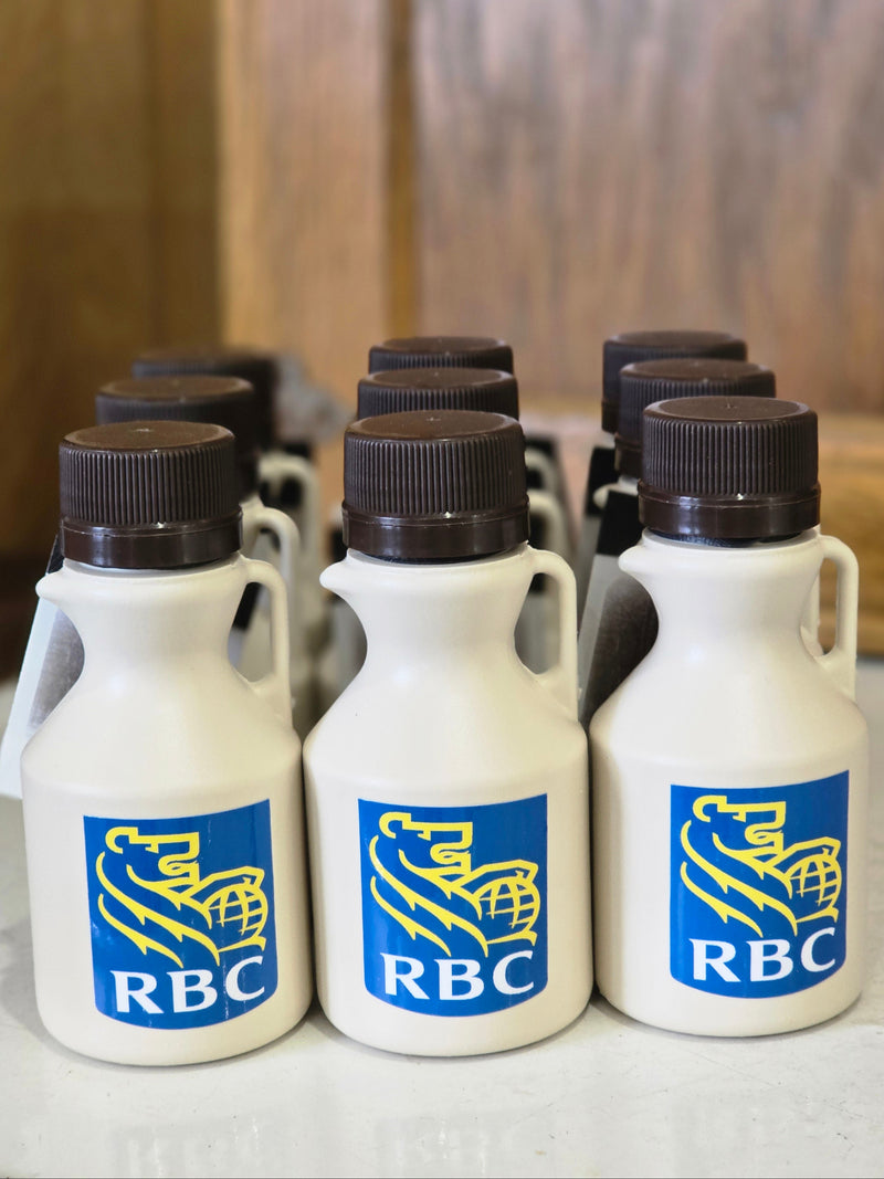Custom labels on 3 brown jugs of Wagler Maple Products pure maple syrup with RBC logo