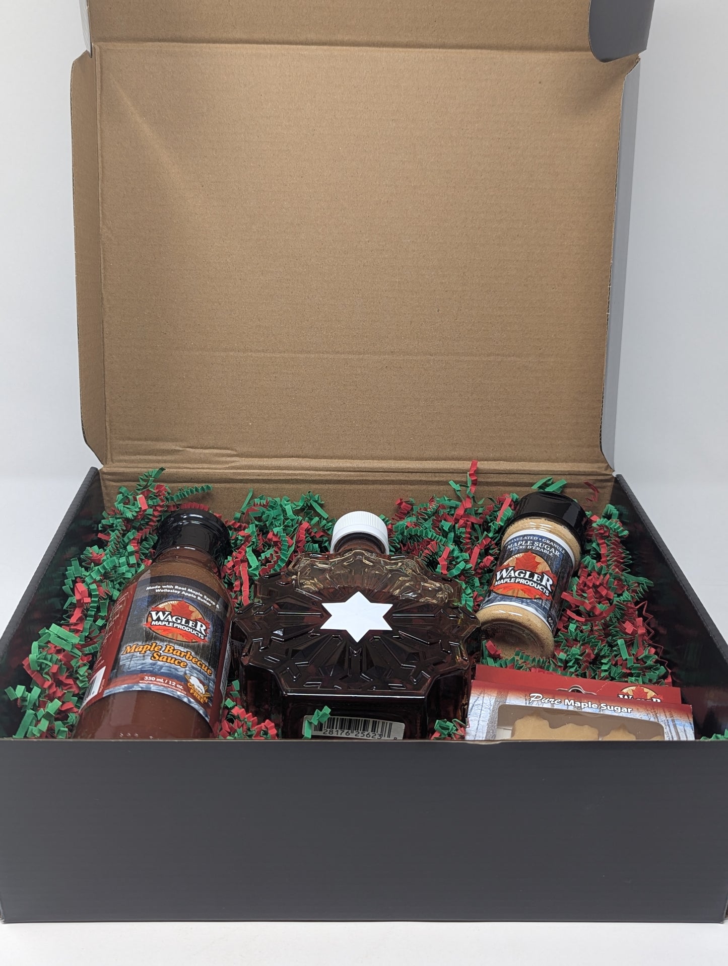 holiday themed gift box with maple syrup and maple treats